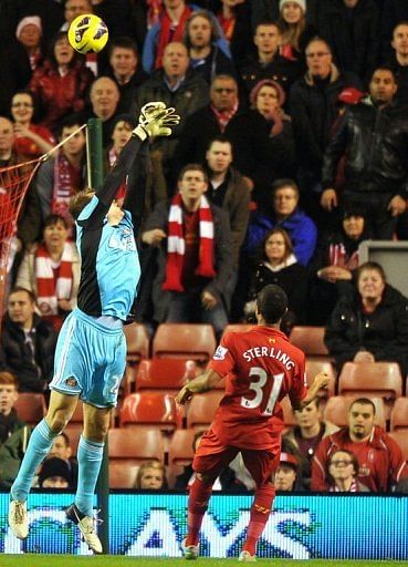Liverpool's Raheem Sterling (R) scores over Sunderland's Simon Mignolet (L) at Anfield on January 2, 2013